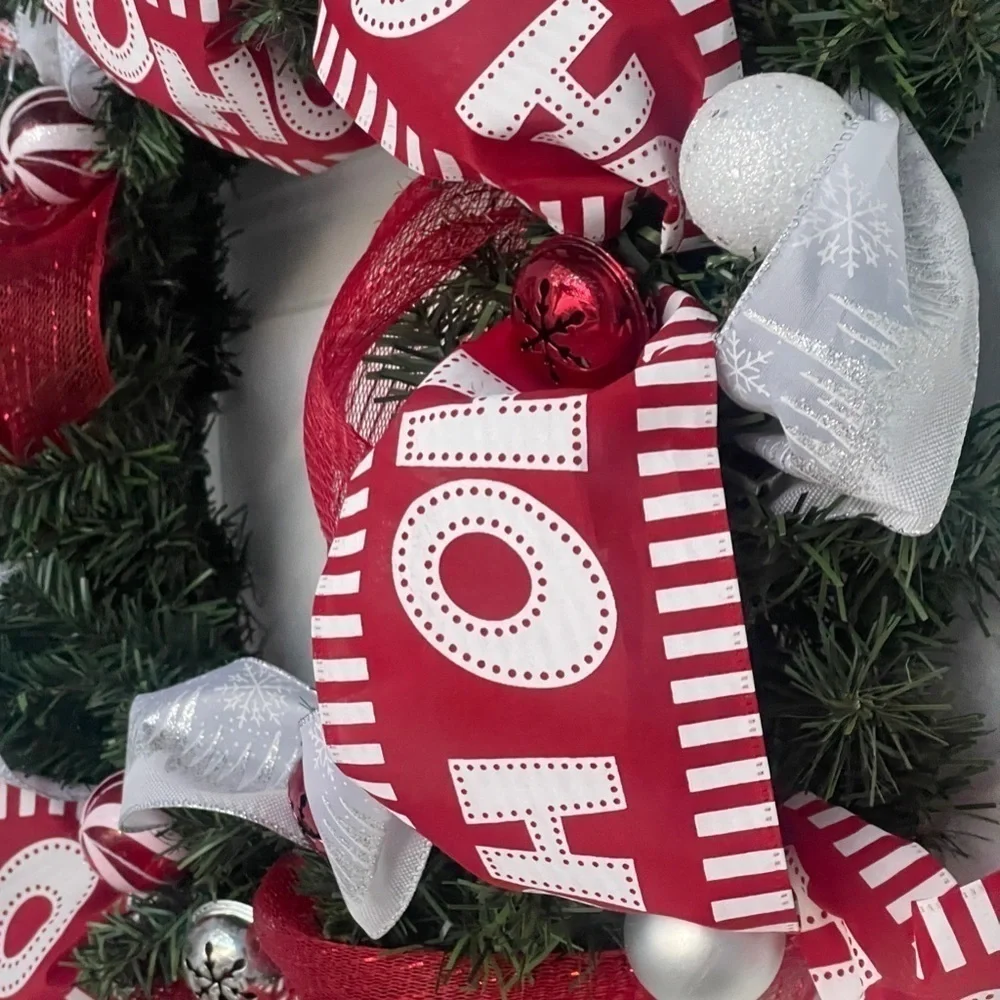 Handmade Christmas wreath, ribbon,bells, and ornaments. Silver, white and red